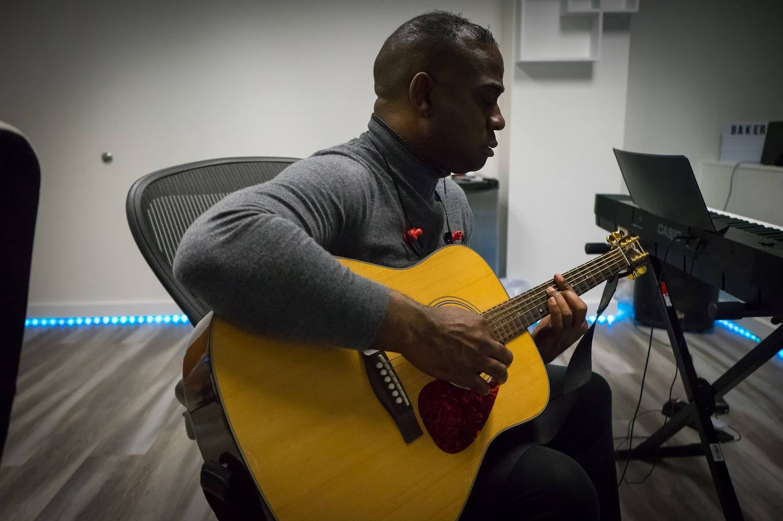 Songwriter recording an acoustic guitar part